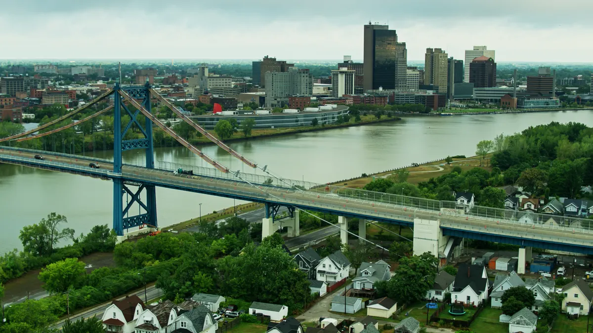 A bridge over a river with the Toledo cityscape in the background.