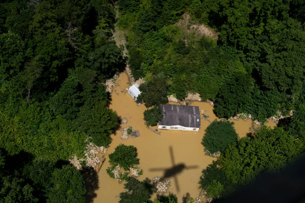 In this aerial view, floodwater surrounds a house.