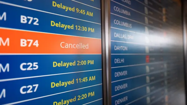 A sign shows multiple canceled and delayed flights.