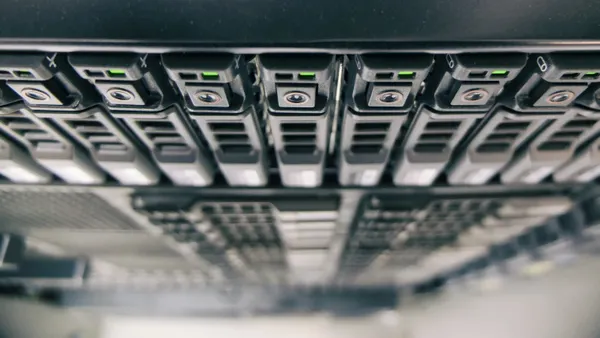 A stack of computer hard drves is show in a close up shot.