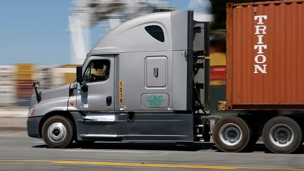 A truck drives through an ocean port in California.