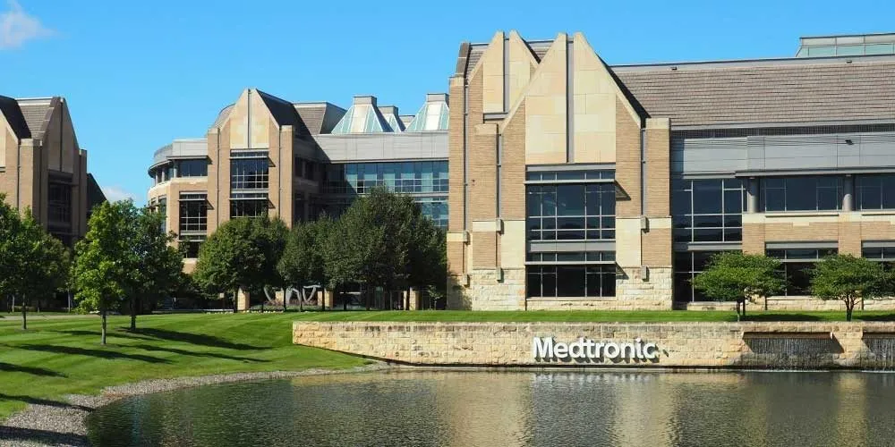 A building in front of a lake with the words 'Medtronic' on a sign.