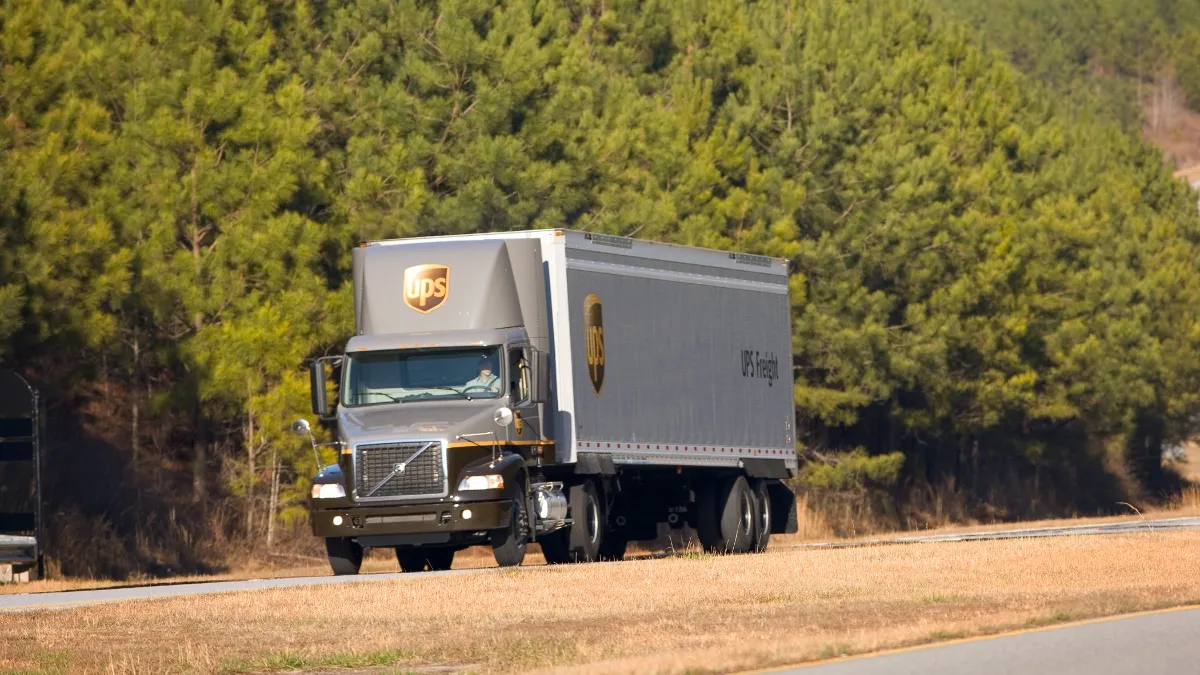 A UPS Freight truck drives on a road