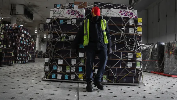 A worker bring boxes of flowers into the Avianca Cargo Warehouse before they are inspected by U.S. Customs and Border Protection Agriculture Specialists.