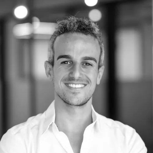 ceo of unit finance itai damti smiles in black and white headshot