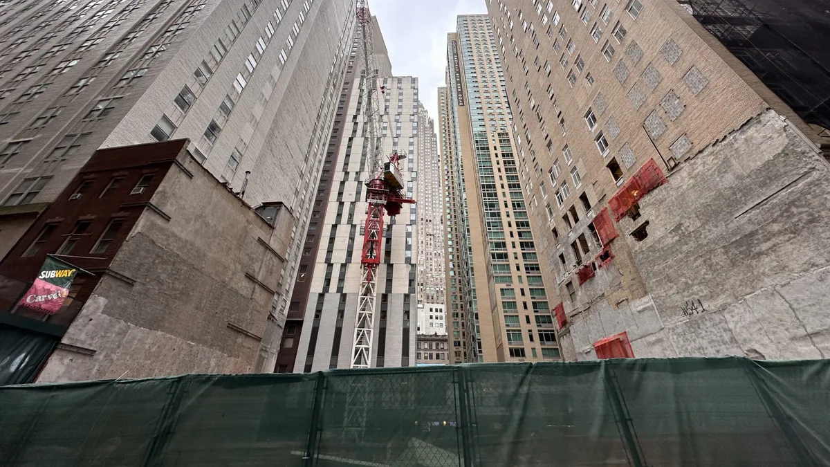 An empty lot in a row of buildings.