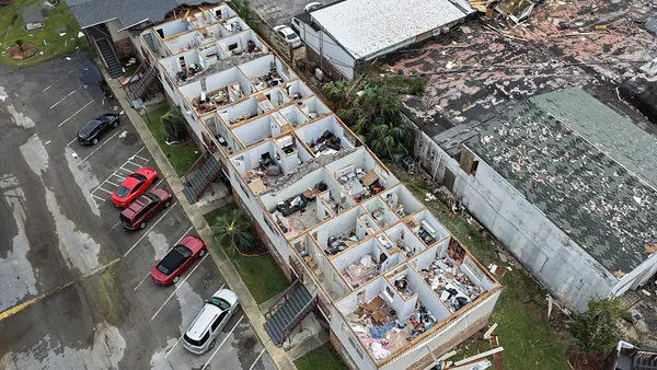 Aerial view of apartment building with roof blown off