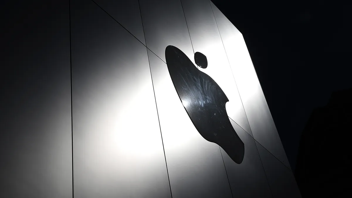 The Apple logo is displayed on the exterior of an Apple Store.