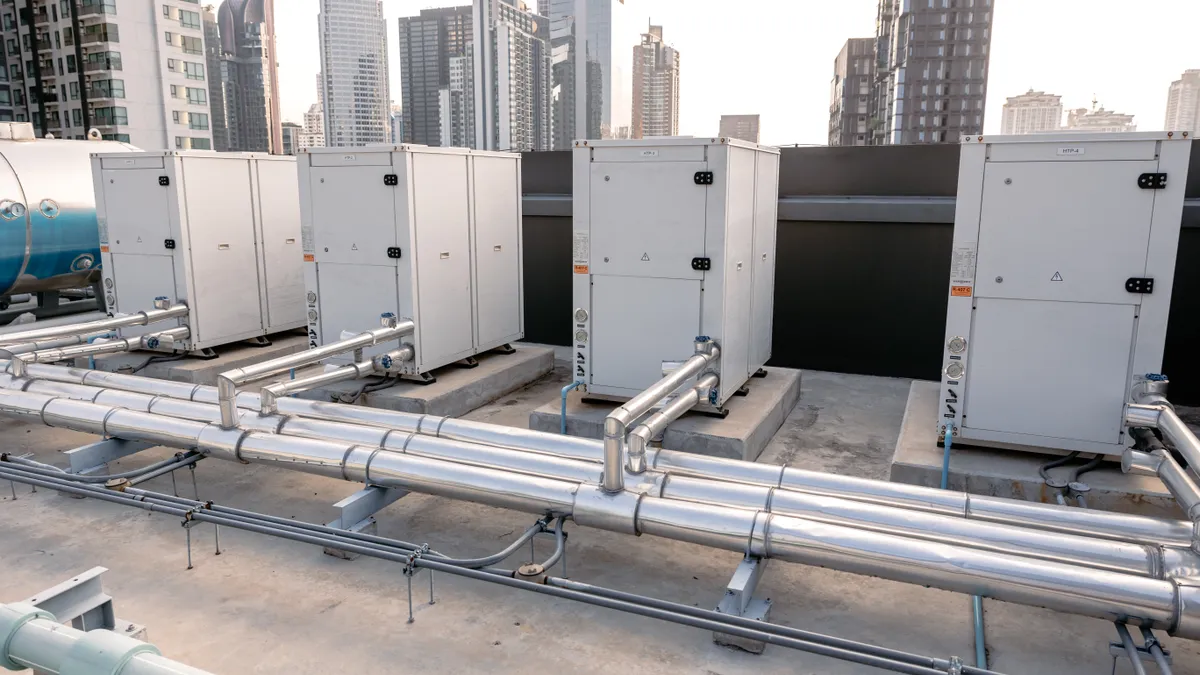 Heat pump compressors installed on the rooftop of a large commercial building