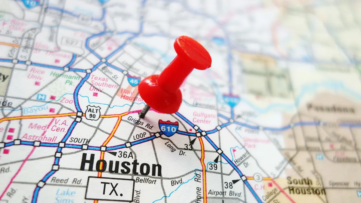 Closeup of a Houston map with a red pin.