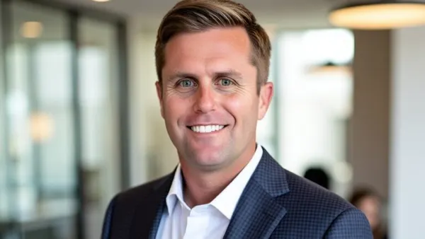 A headshot of Adam Patenaude