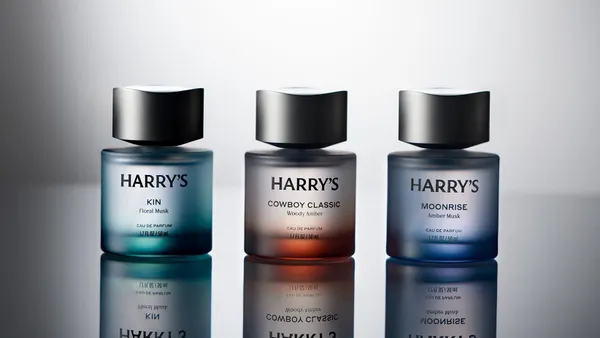 Three bottles of Harry's cologne products against a gray backdrop