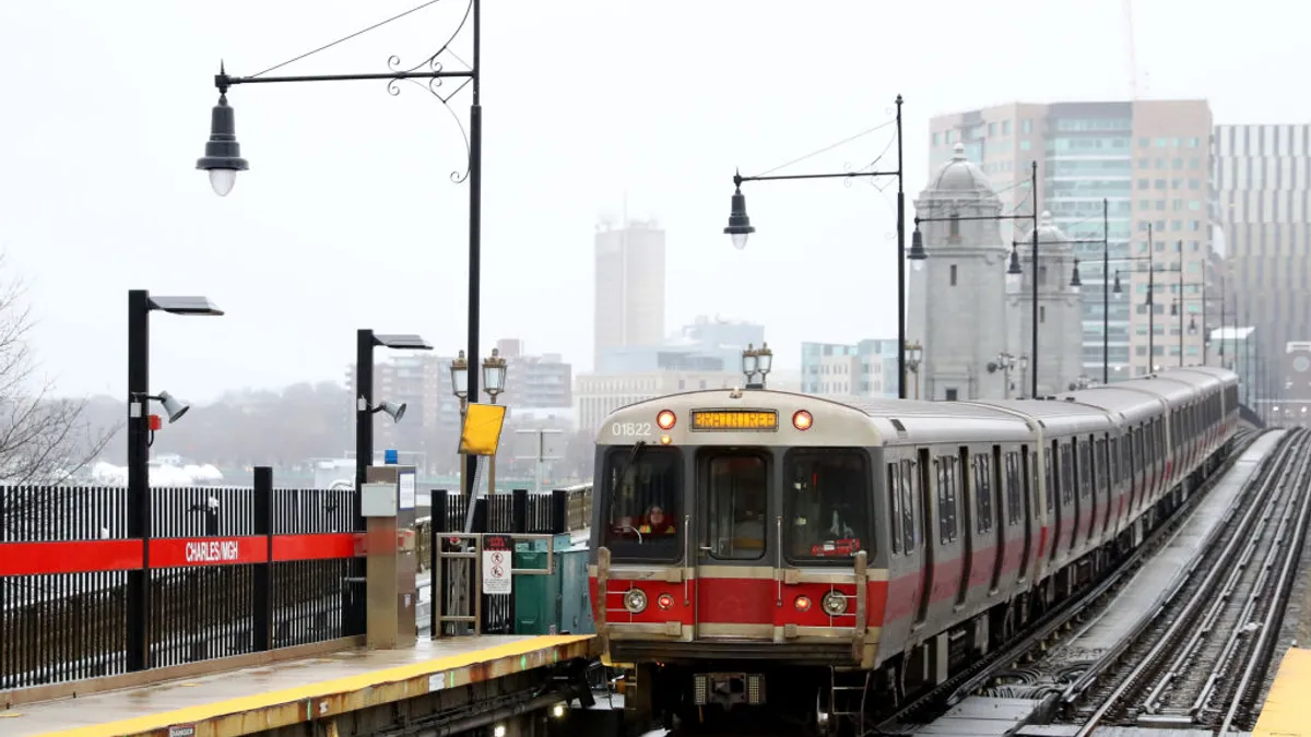 Boston MBTA train to Braintree at an outdoor station in foggy, wet weather