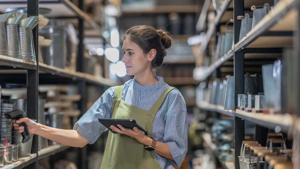A woman verifies inventory with a handheld scanner