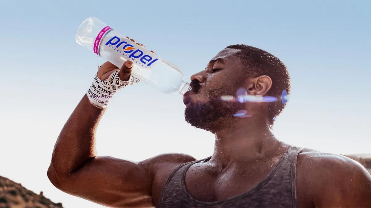 Actor Michael B. Jordan drinks from a bottle of Propel Fitness Water