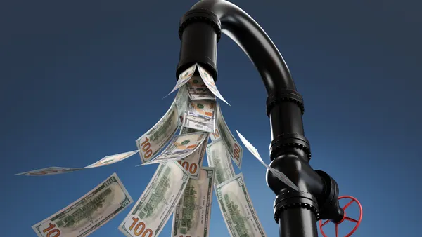 banknotes flowing out of a black plumbing pipe with a valve having a red handle wheel