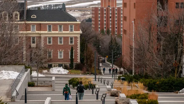 Students walk on the Washington State University campus on a cloudy day.
