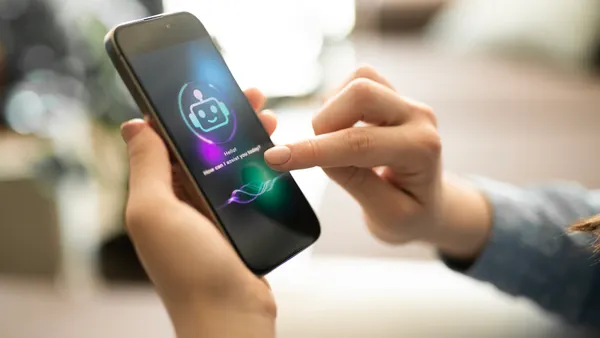 A person holds a smartphone with an AI chatbot app on its screen.