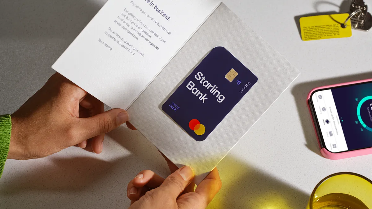 A person holds a Starling Bank card