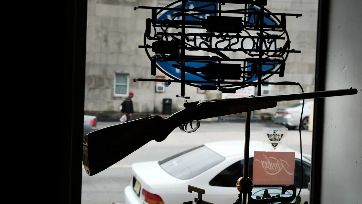 A rifle is seen in a store window