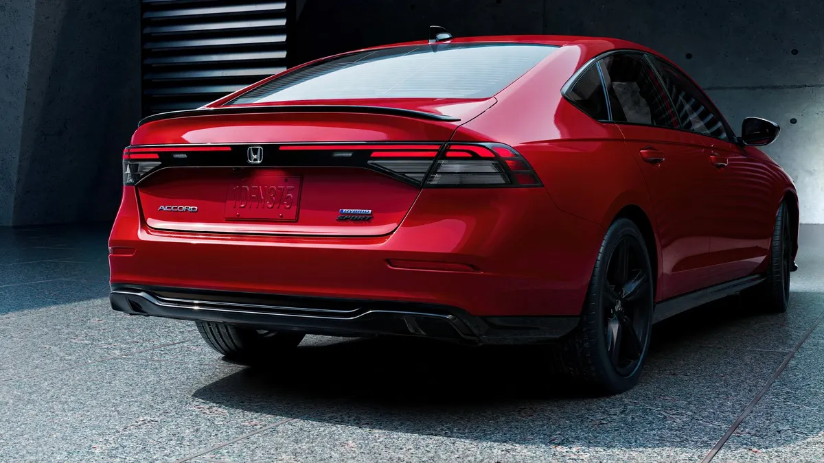 A right rear view of a red 2023 Honda Accord Hybrid sedan.