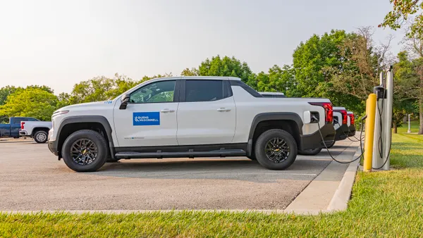 A Burns and McDonnell Electric Fleet vehicle charging at a station.