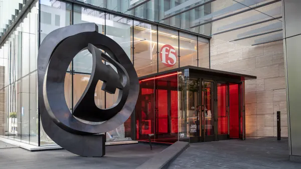 The entry to a large glass building with the F5 corporate logo is pictured.