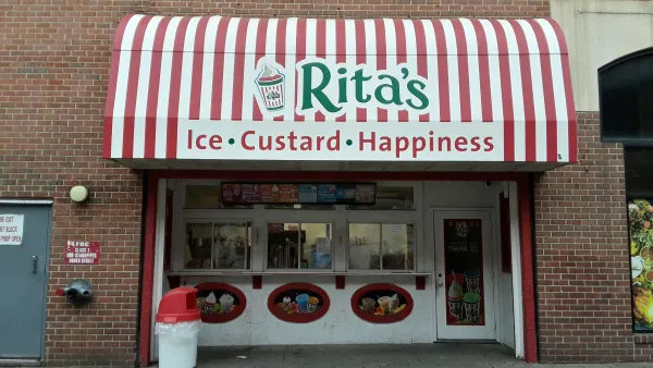 An image of a brick building with a red and white striped sign that says "Rita's Ice, Custard, Happiness"