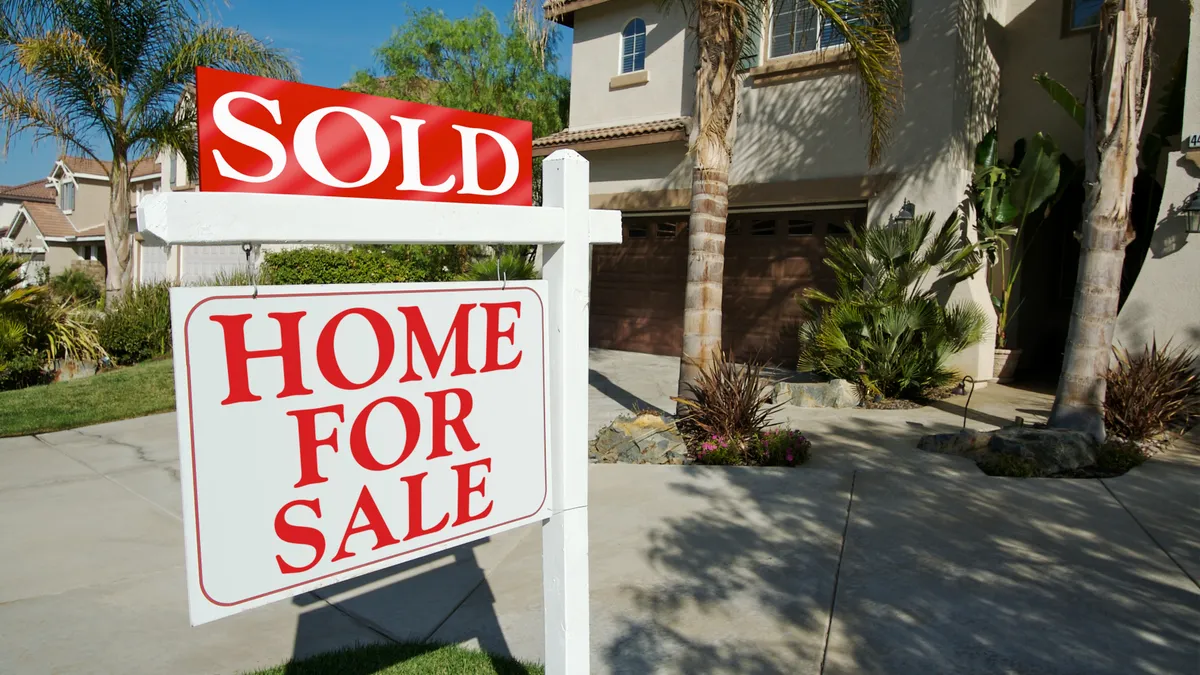 A house with a sold sign on it