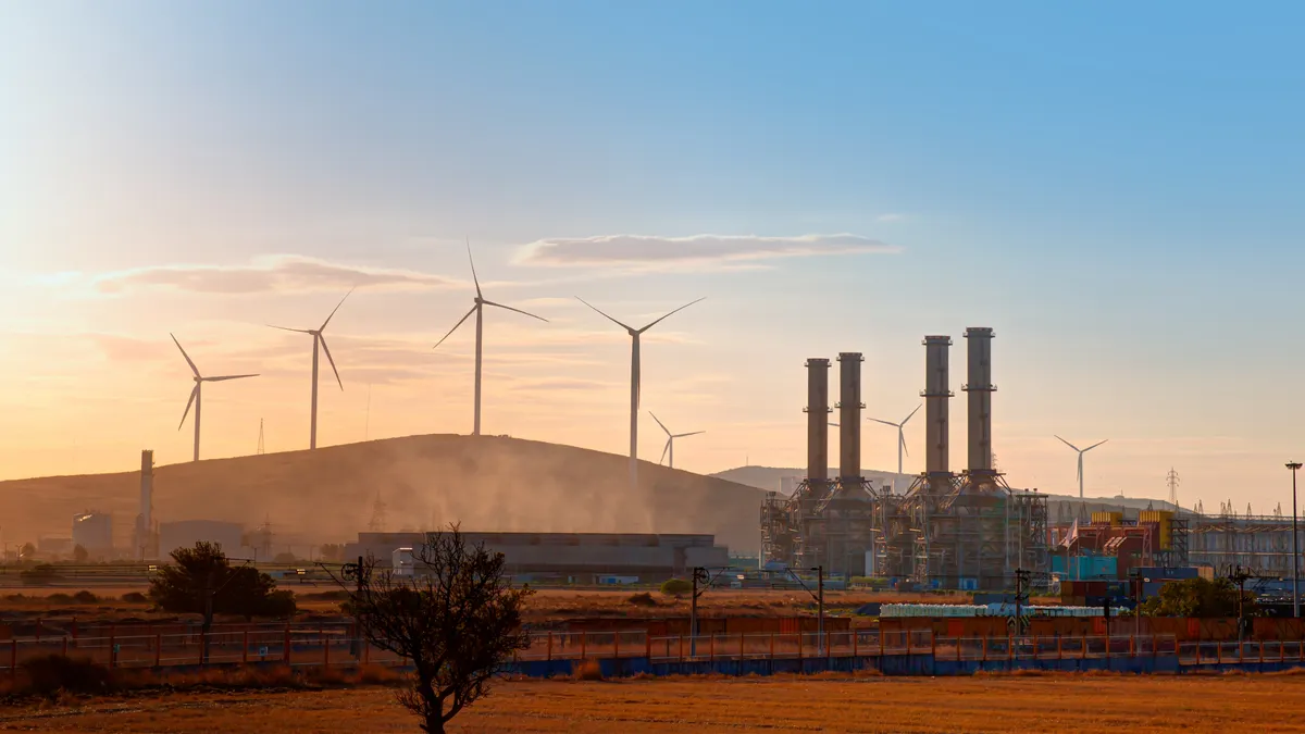 Silhouette of Natural gas processing plant with Renewable energy wind turbines generating electricity