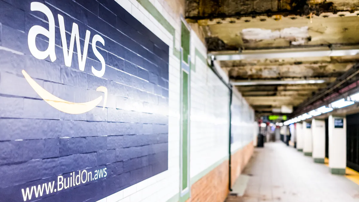 An Amazon Web Services advertisement ad sign on the wall in underground transit platform in NYC Subway Station.