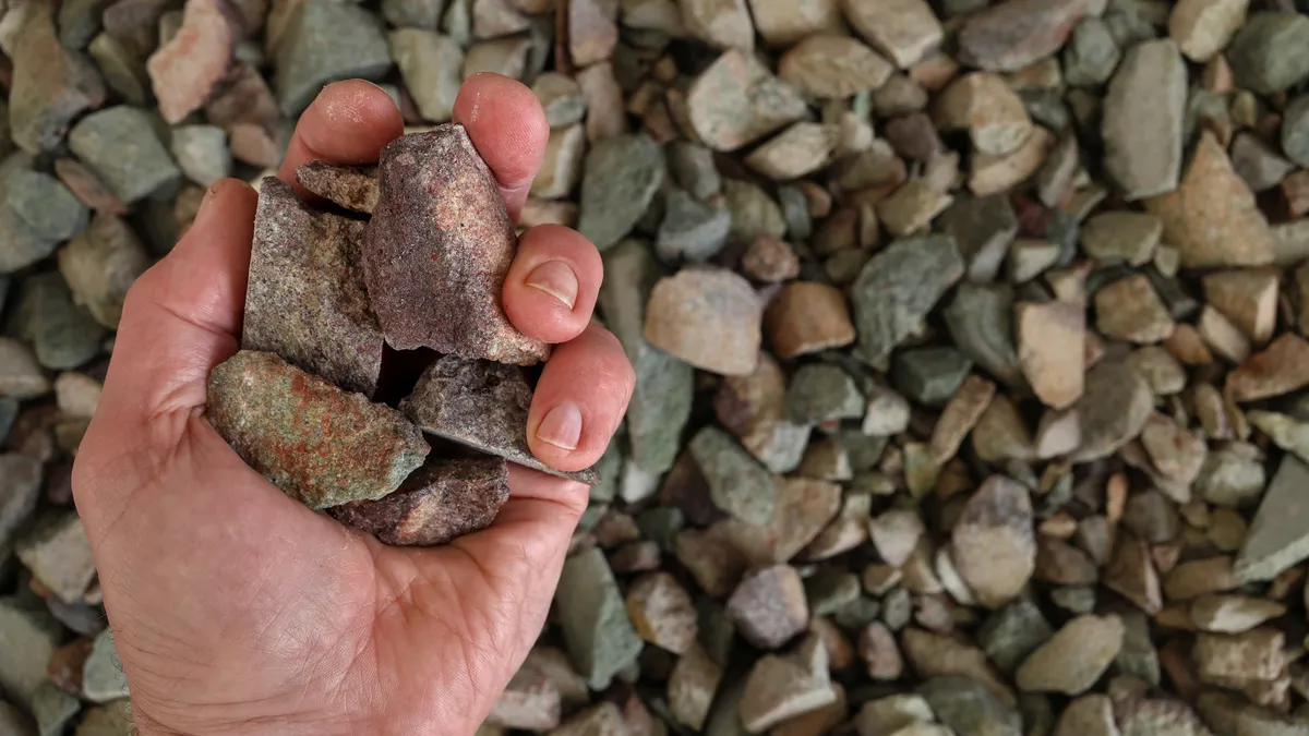 Rare earth ore held in partially closed hand