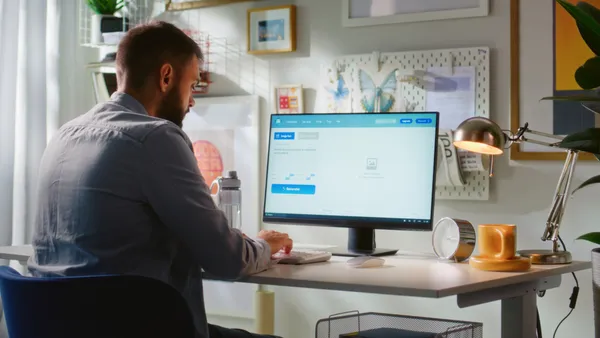 a worker consults an AI app on a desktop computer