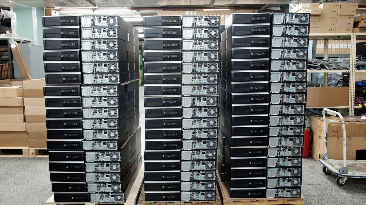 Computers stacked on a moving pallet.