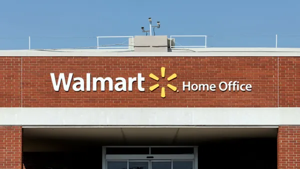 A sign on building reads "Walmart Home Office"
