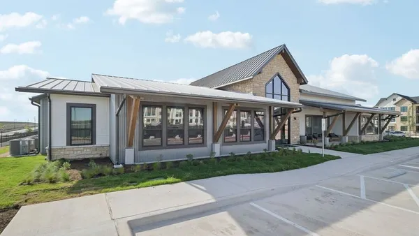 Apartment office with parking lot in front.