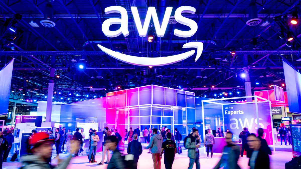 Attendees walk through an expo hall at AWS re:Invent 2023, a conference hosted by Amazon Web Services, at The Venetian Las Vegas on November 28, 2023 in Las Vegas, Nevada.