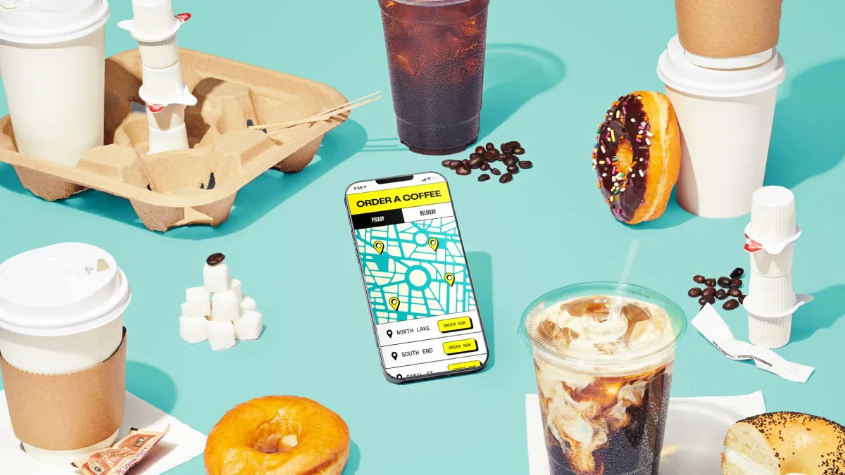 An image of a donut and other food items with a smartphone in the foreground