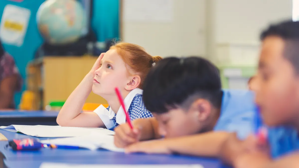 A girl student and two boy students are shown appearing to be bored, tired and daydreaming in a classroom.