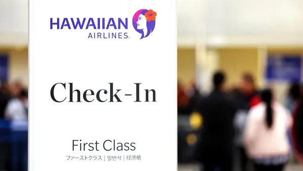 he Hawaiian Airlines logo is displayed at a check-in area at Los Angeles International Airport (LAX) on December 4, 2023 in Los Angeles, California.