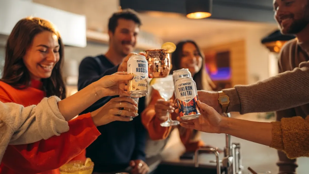 A group of people drink cocktails together.