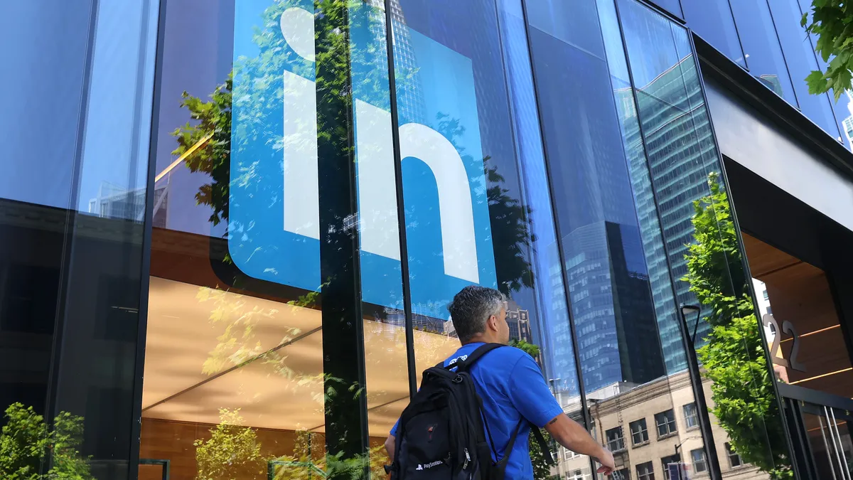 A pedestrian walks by a sign at a LinkedIn office on July 26, 2023 in San Francisco, California.