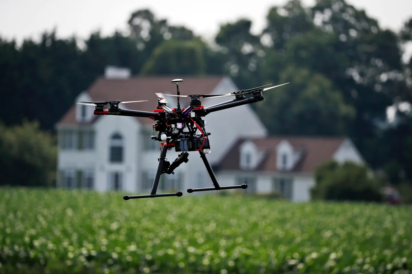 Drone hovers above farmland