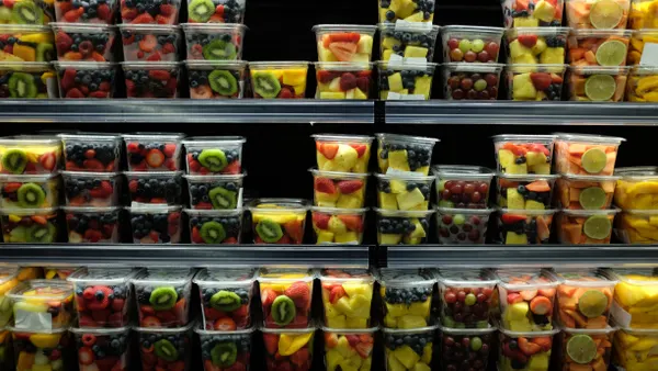 Cut fruit in plastic packaging on store shelves