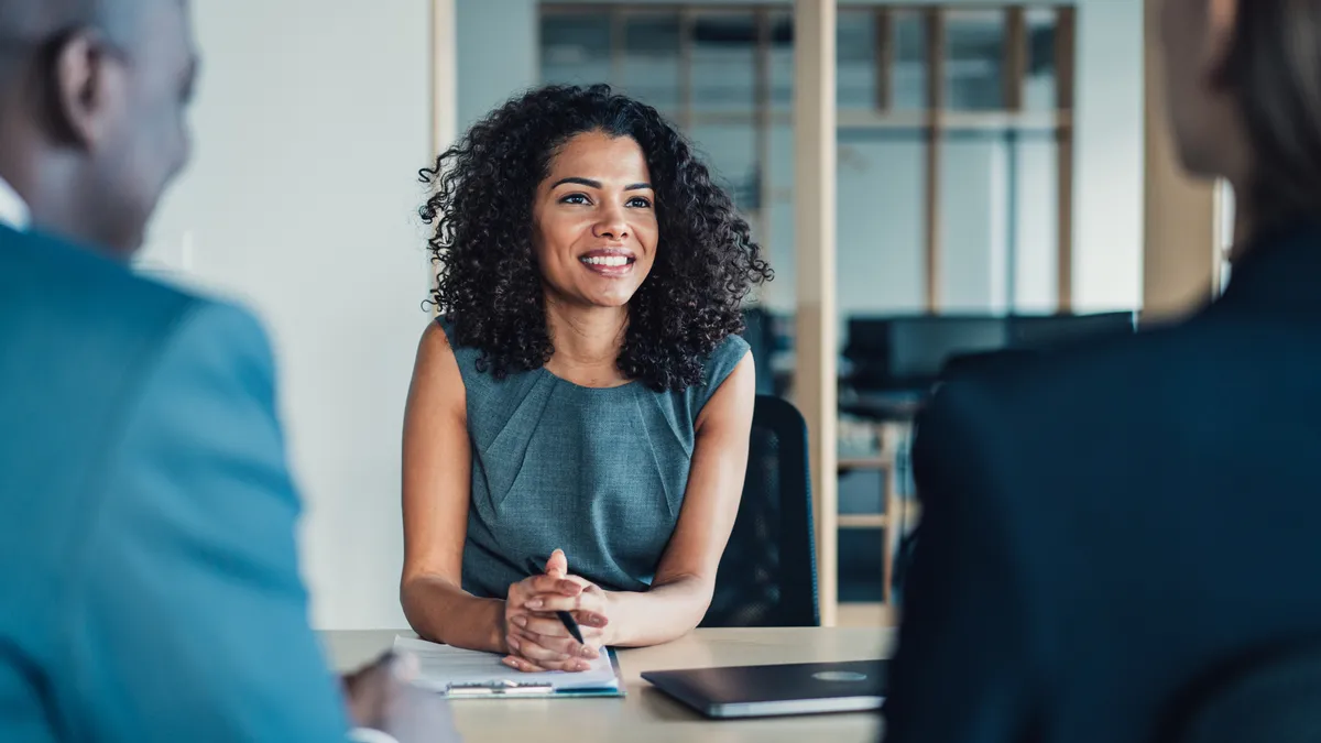 A general counsel meeting with two of her lawyers