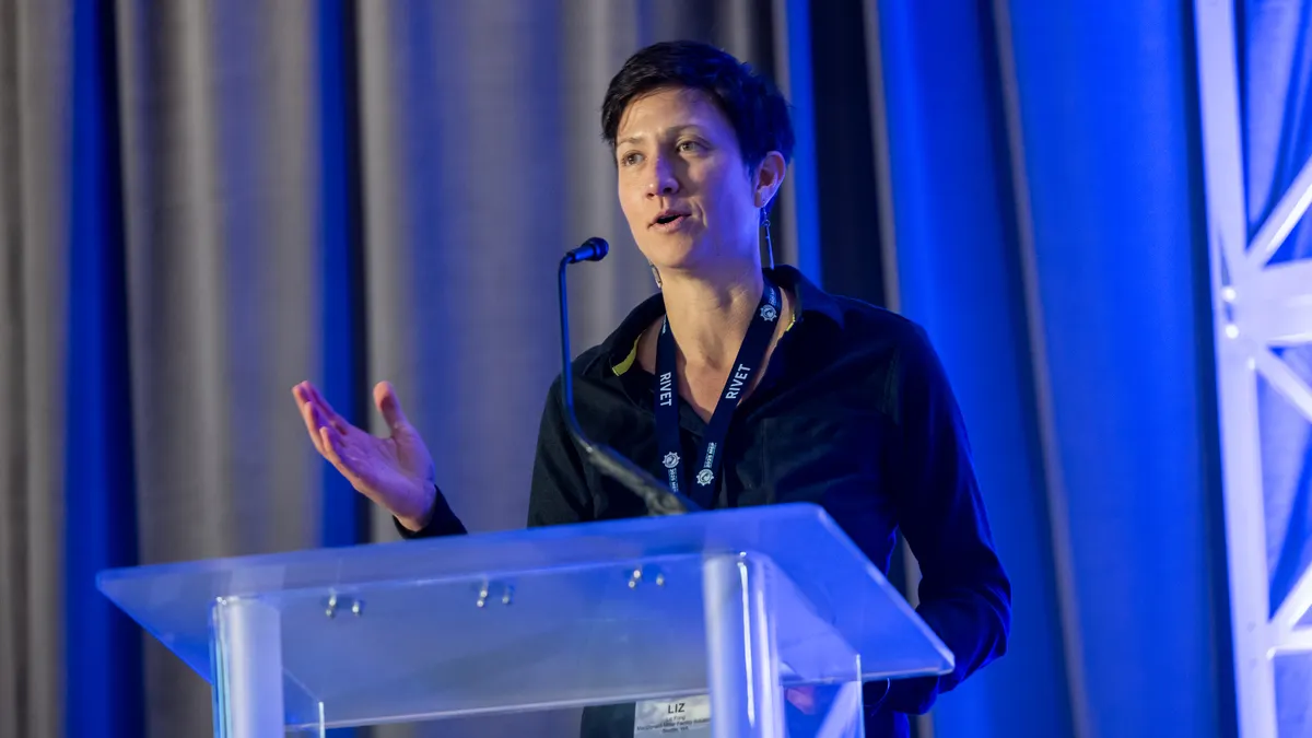 A woman gives a speech at a lectern