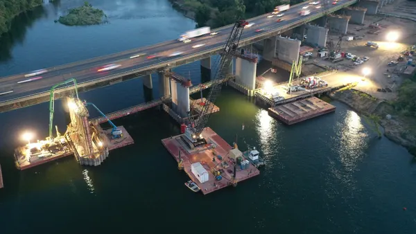 An aerial shot shows night work on a bridge crossing the Sacramento River.