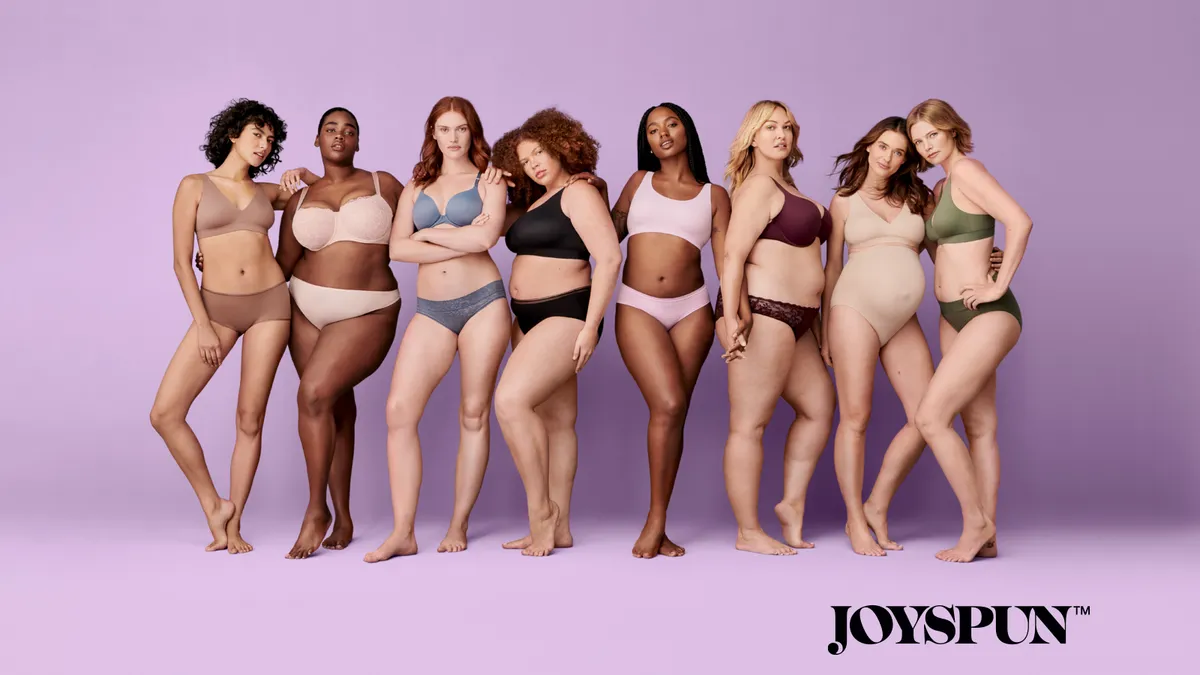 Group of people of different races and sizes lined up wearing underwear products.