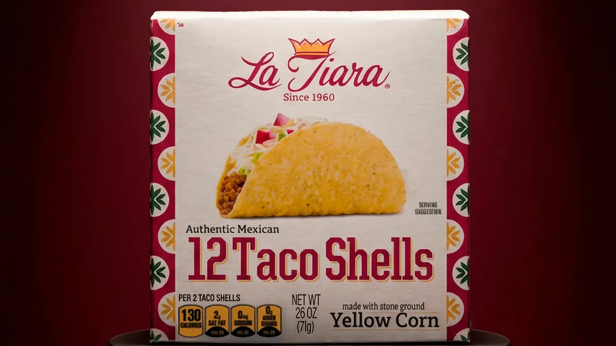 A box of La Tiara taco shells sits displayed on a round table.