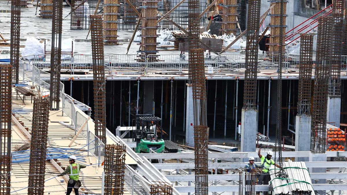 Construction workers help build a mixed-use apartment complex which will hold over 700 units of apartment housing and 95,000 square feet of commercial space on January 25, 2024 in Los Angeles, Califor